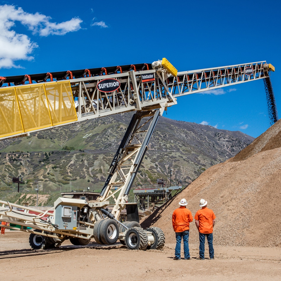 Superior Telestacker Conveyor working as two men watch