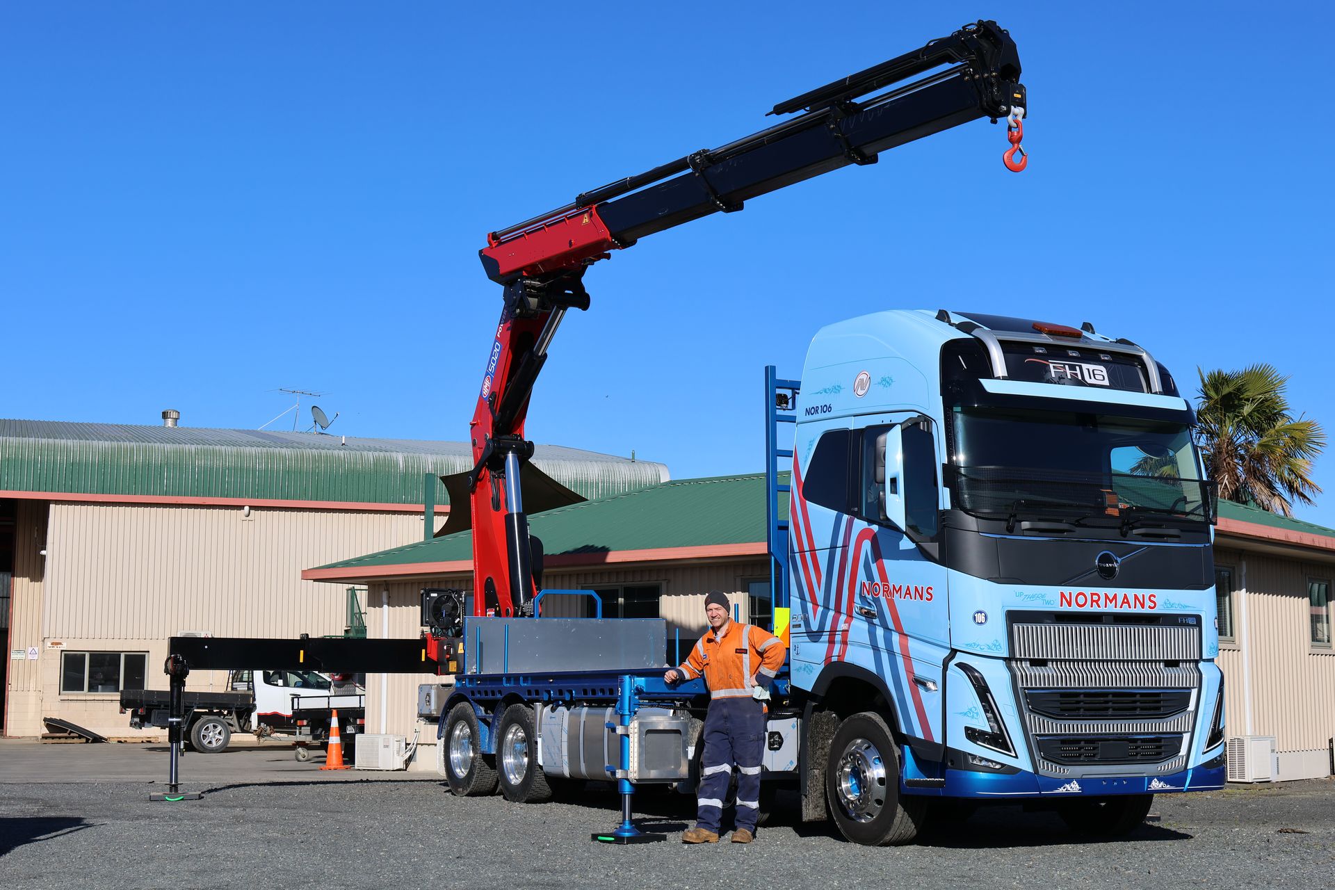 Operator at the side controls of the HMF 5020 K6 crane on the Normans Transport Volvo FH16