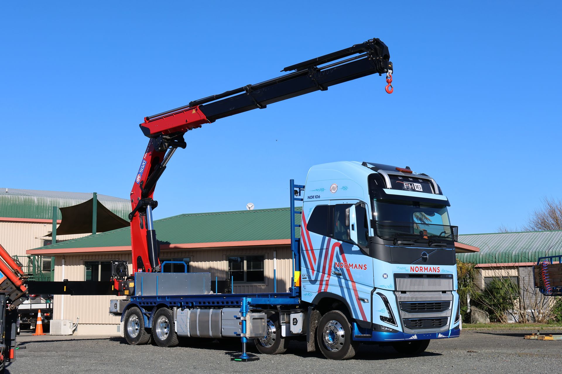 HMF 5020 K6 crane boom extended on the Normans Transport Volvo FH16 with stabilisers deployed