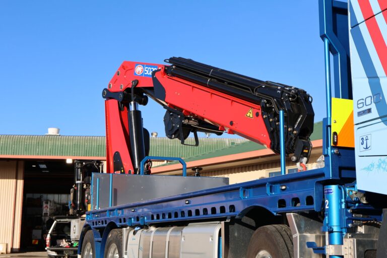Close-up of the HMF 5020 K6 crane mounted behind the cab of the Volvo FH16