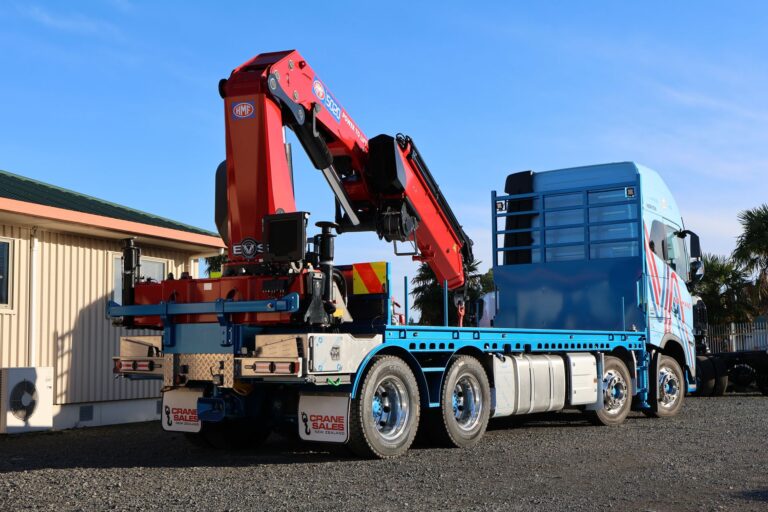 Rear three-quarter view of the Volvo FH16 crane truck with the HMF 5020 K6 crane stowed behind the cab